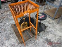 STOOL, ORANGE WORKBENCH AND A PIPE VICE