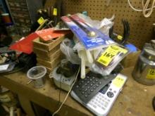 Group of Items in Middle of Work Bench - Label Maker, Calculator, Cross Arm