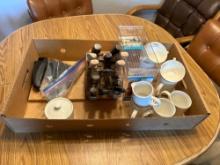 Assorted coffee cups and knives with sharpeners