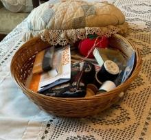 Sewing items in a home made sewing basket.