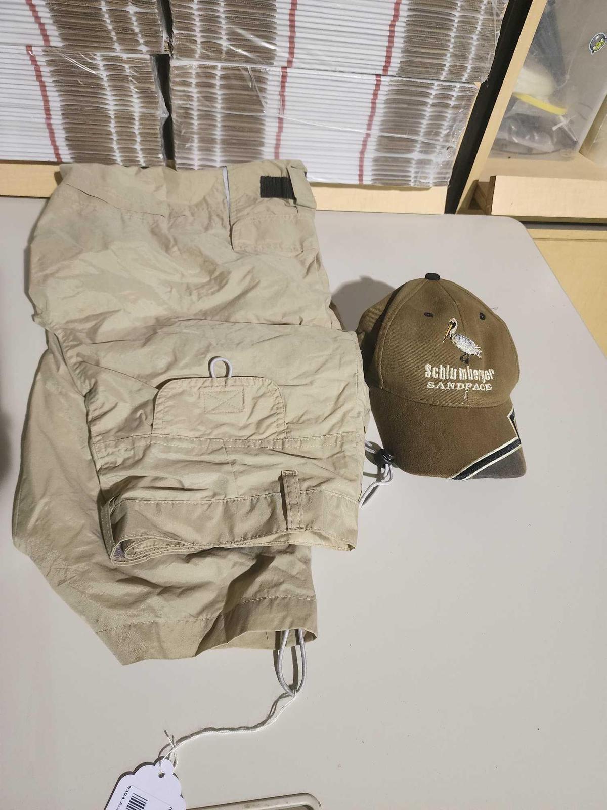 One pair of lightweight khaki pants and a baseball style cap. Used.
