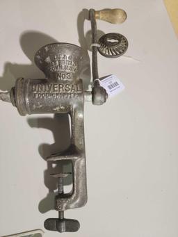One cast metal universal table mount food grinder. Used.