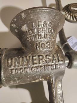 One cast metal universal table mount food grinder. Used.