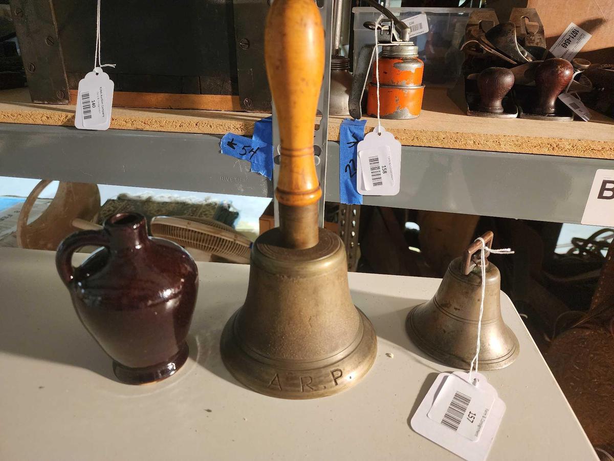 One ceramic Vermont maple syrup container, and two brass bells, one with wood handle. Used.