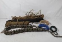 One bag of black plastic nylon strap connectors, three large rolls of paracord and four woven
