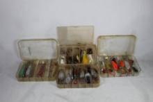 Four plastic compartment boxes with fishing lures and spinners. Used.