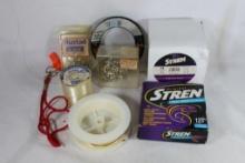 Five spools of fishing line and two packages of fishing hooks.