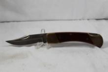 Schrade Uncle Henry folding hunter with 3.5 inch blade. Wood scales. Leather belt sheath. Appears as