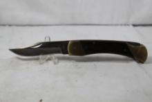 Schrade folding hunter model LB7. 3.75 inch blade. Wood scales. Original leather sheath. In good
