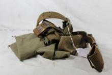 Web belt with one magazine pouch, one cloth bandelier and one shotshell belt. Used.