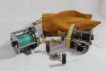 Leather pouch with two fishing reels. Used.