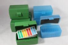 Four green and three lt blue MTM 50 round small rifle cartridge ammo boxes.