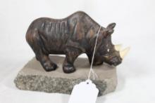 Rhino statue on granite slab