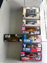 Box of Texas Motor Speedway Diecast Replica Cars and Hot Wheels Mystery Car