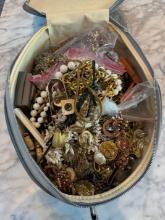 Large lot of unsorted jewelry from estate. In old vintage travel case