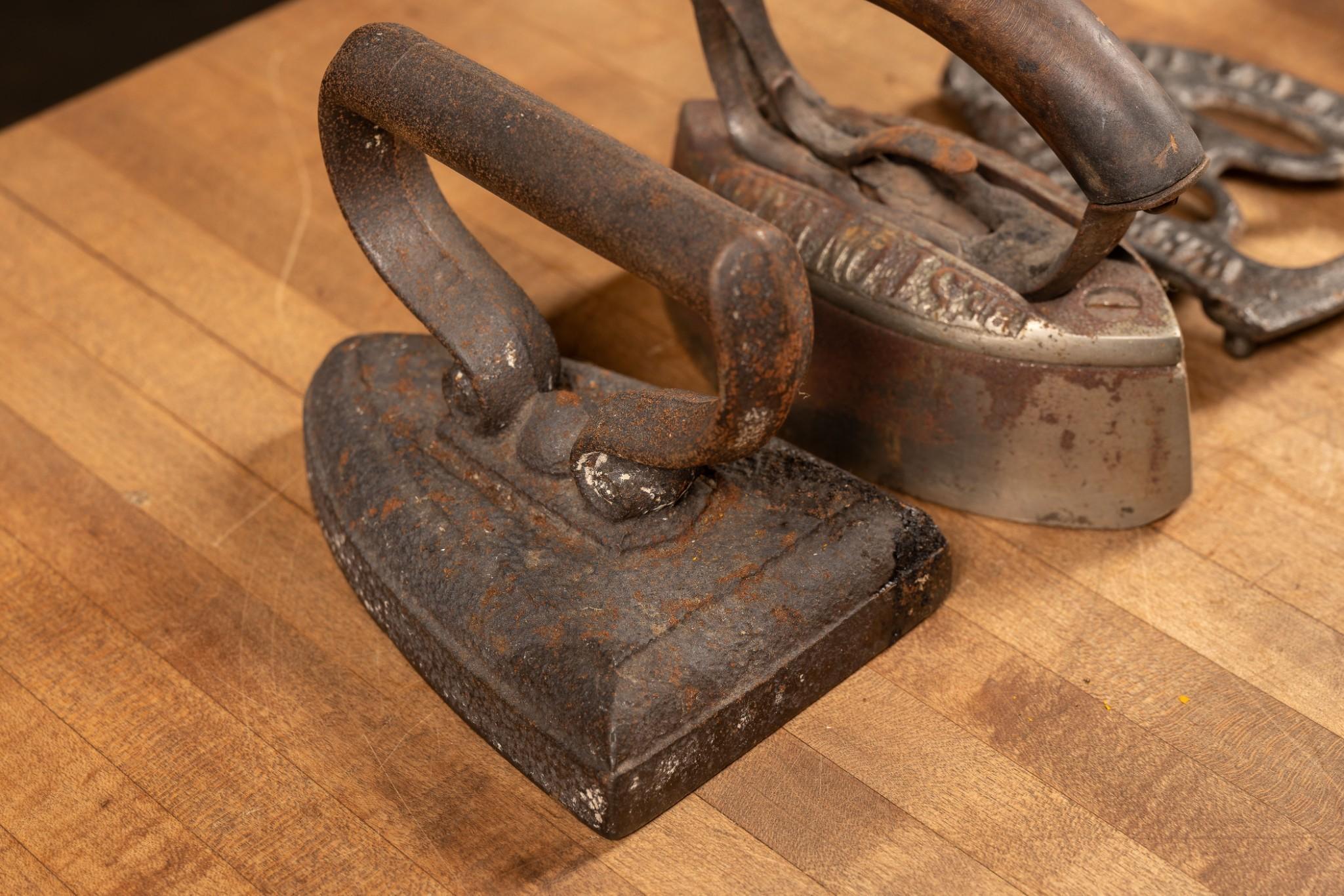 Three Antique Clothes Irons and Trivet