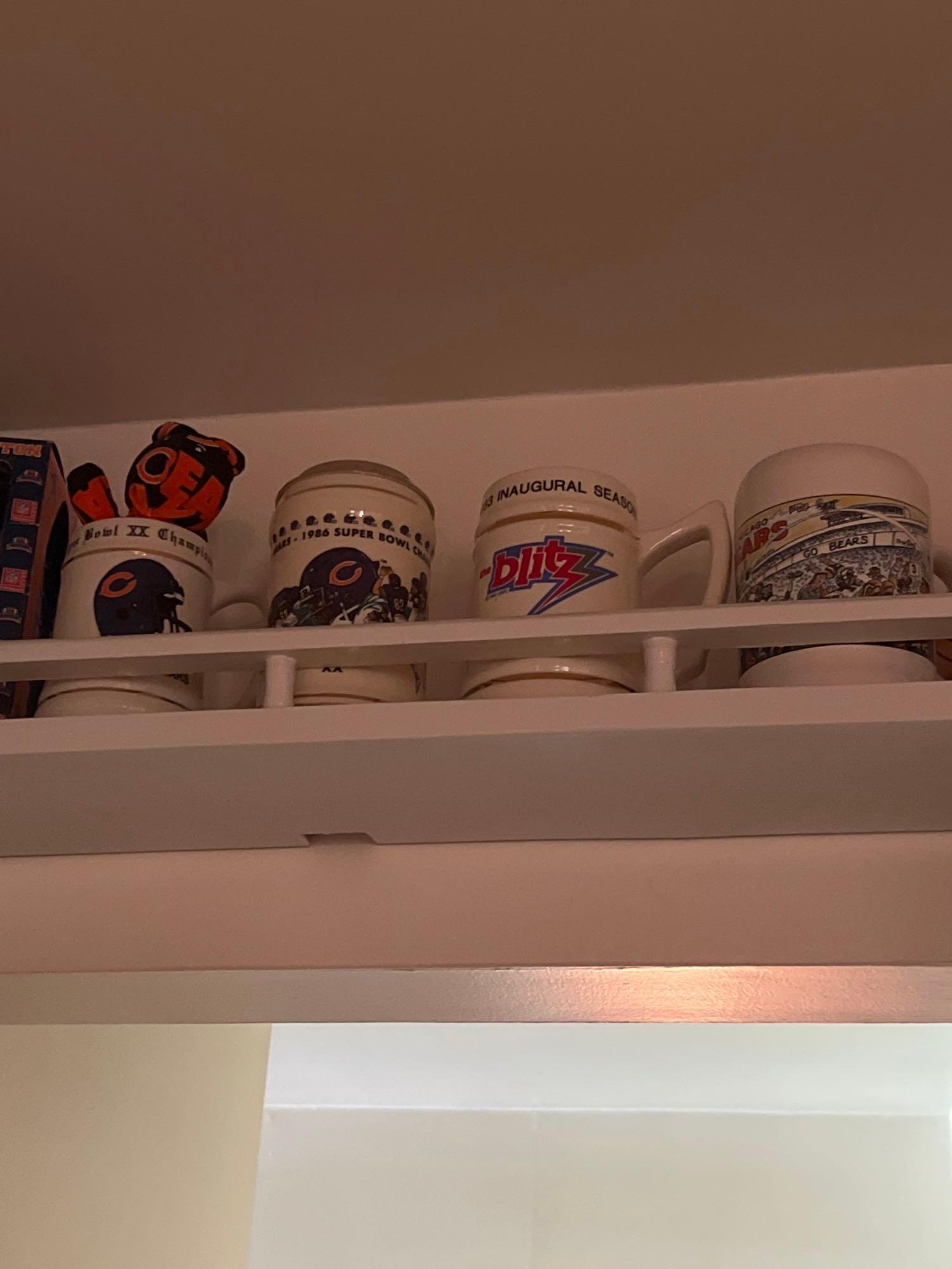 long shelf with bobbleheads mugs steins and more