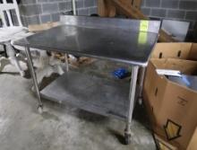 stainless table w/ backsplash & undershelf, on casters