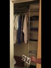 Bedroom closet shirts, ties, ironing board