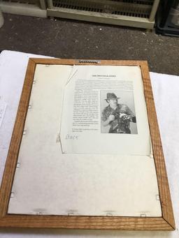 Oak framed photo of husky dog info on back of famous Photographer