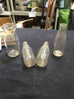 group of three baby bottles, one cream bottle
