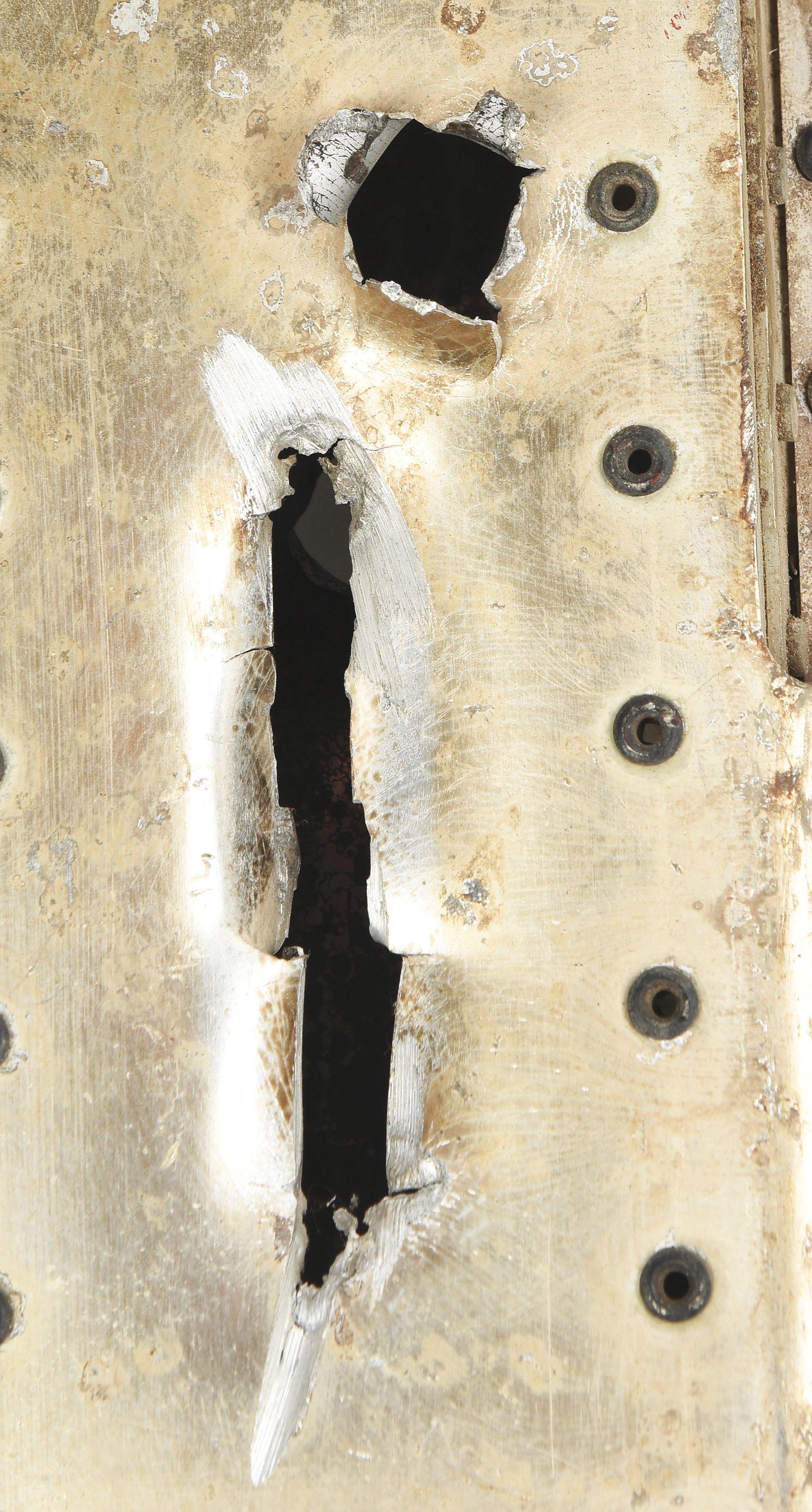 RECOVERED PANEL FROM A MESSERSCHMITT WITH BULLET HOLES.