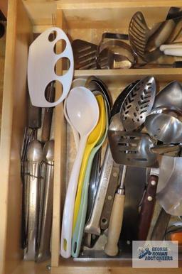 Drawer...full of assorted...spoons,...tongs and other utensils
