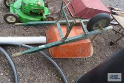 Orange wheelbarrow with pneumatic wheel
