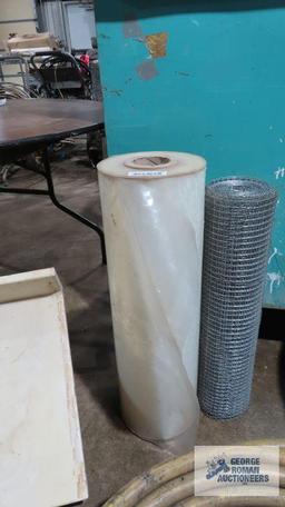 Plastic sheeting and roll of wire fencing