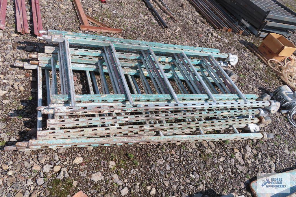 Lot of green roll about scaffolding pieces with boards