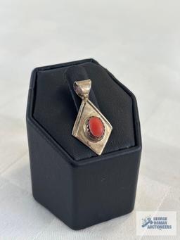 Silver colored with orange stone pendant, marked Sterling