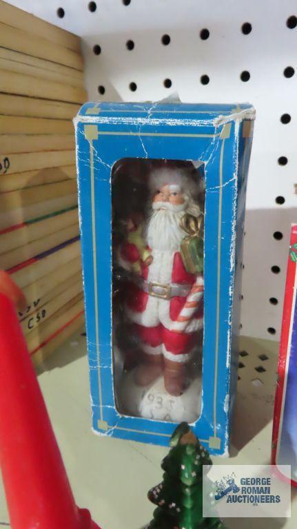 Santa figurines, Coca-Cola ornament, and Christmas candles