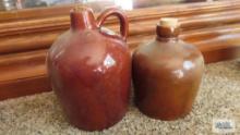 Two Brown jugs with corks