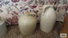 Two cream colored jugs with corks