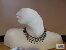 Unusual bust of partial face with necklace