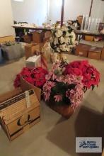 Variety of poinsettia arrangements in planters and baskets and vases