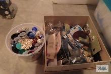 Containers of craft items, including buttons. Embellishments and stickers.