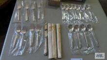 Sterling flatware, 4 piece place setting with extra spoons.