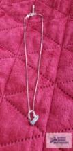 Silver colored heart pendant with three colored gemstones marked 925 on silver colored box chain