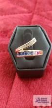 Gold colored ring with clear and colored stones marked 10K 3.0 G (Description provided by seller)