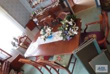Dining room table with one leaf and six chairs with needlepoint seats