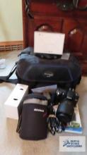 Nikon D80 with lens, two batteries, charger, booklets, lens case and professional bag