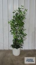 Artificial plant with plastic planter. approximately 73 in. tall