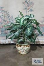 Oriental planter with artificial plant. plant is approximately 34 in. tall. Planter is 9-1/4 in.
