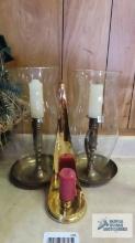 Lot of brass candlesticks. Two have hurricane shades.