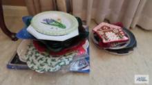 Paper doilies, Plastic ware trivets, and...Christmas dishes