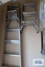 6 ft and 3 ft aluminum step ladders. The 6 ft ladder has damage to the top