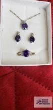 Silver colored purple gemstone necklace, earrings, and ring set