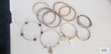 Variety of bangle bracelets, some have charms