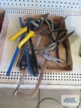 assorted tools including tin snips, pliers, hacksaw with extra blades